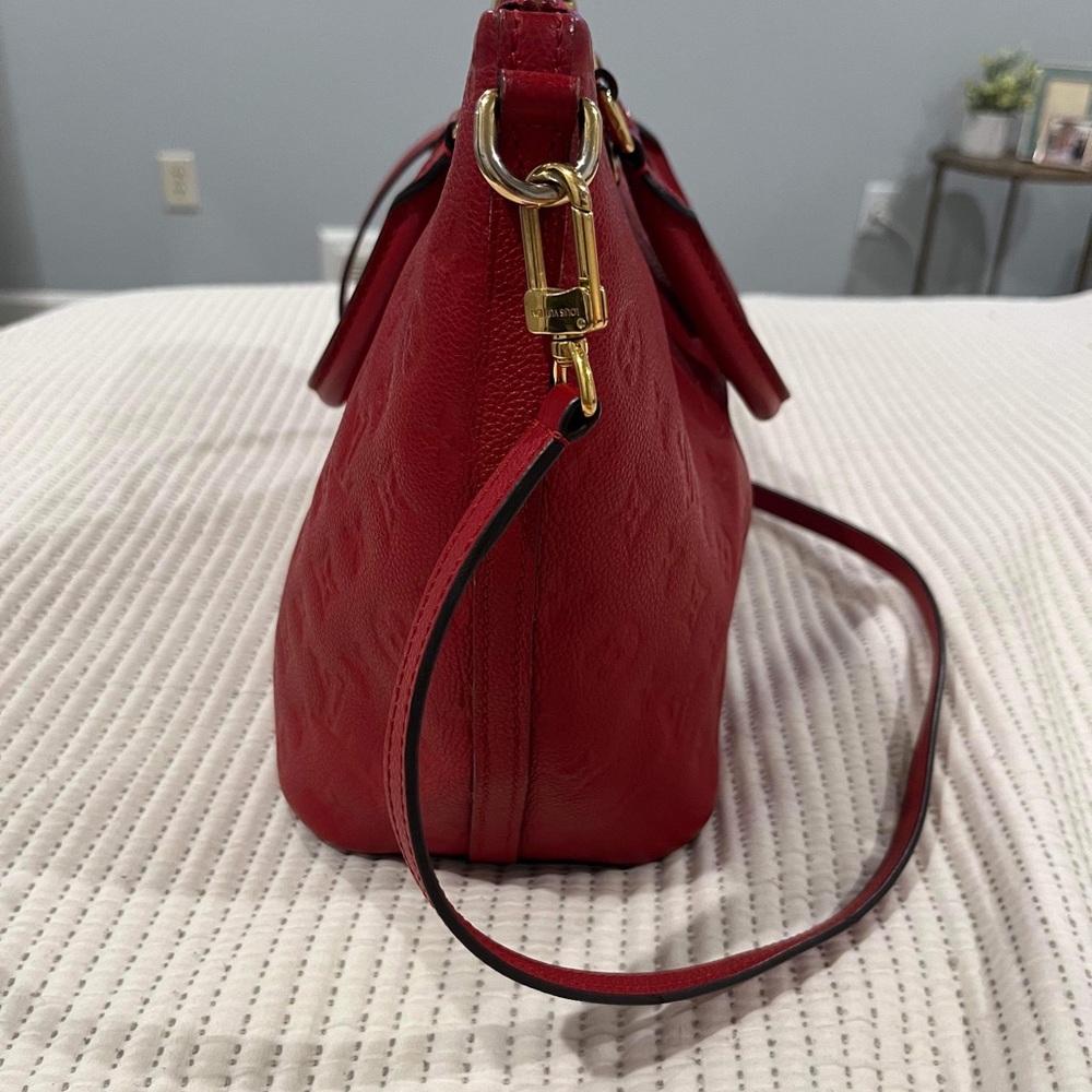 Louis Vuitton Mazarine MM in red.